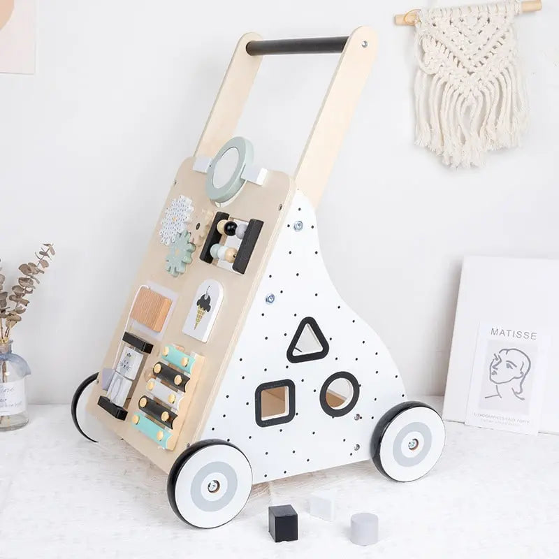 Un Trotteur pousseur bébé multi-activités en Couleurs pastel.