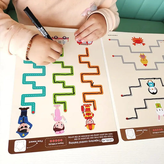 Un enfant dessine sur une table avec un marqueur.