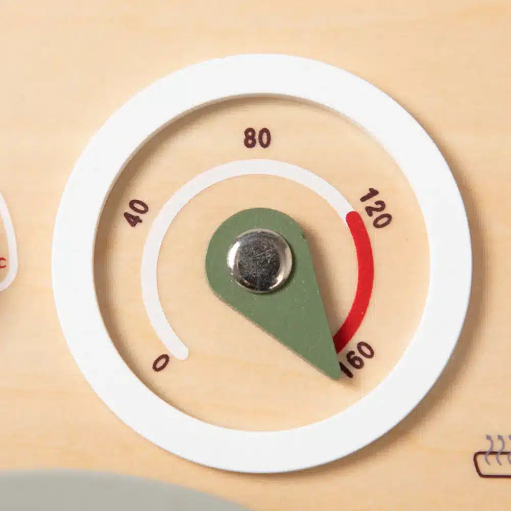 Un gros plan d'un thermomètre sur une surface en bois.