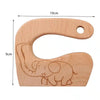 Un anneau de dentition en bois avec un éléphant dessus.