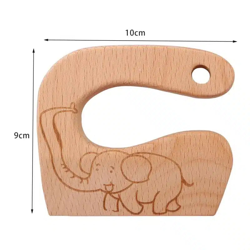 Un anneau de dentition en bois avec un éléphant dessus.