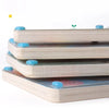Une pile de puzzles en bois, dont un Labyrinthe Magnétique en Bois - Puzzle Montessori, conçu dans le style Montessori.