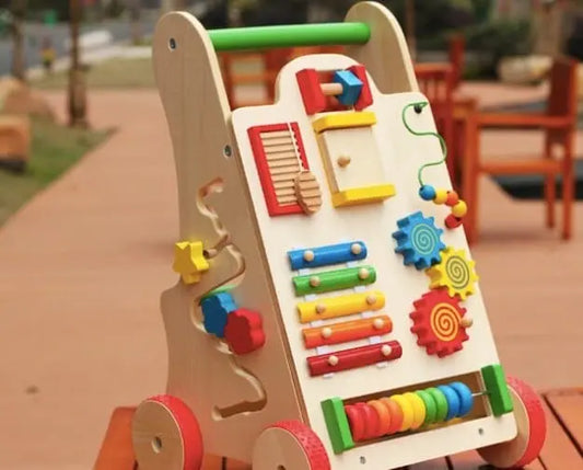 Un Chariot de Marche Bébé - Coloré vibrant sur une table en bois.