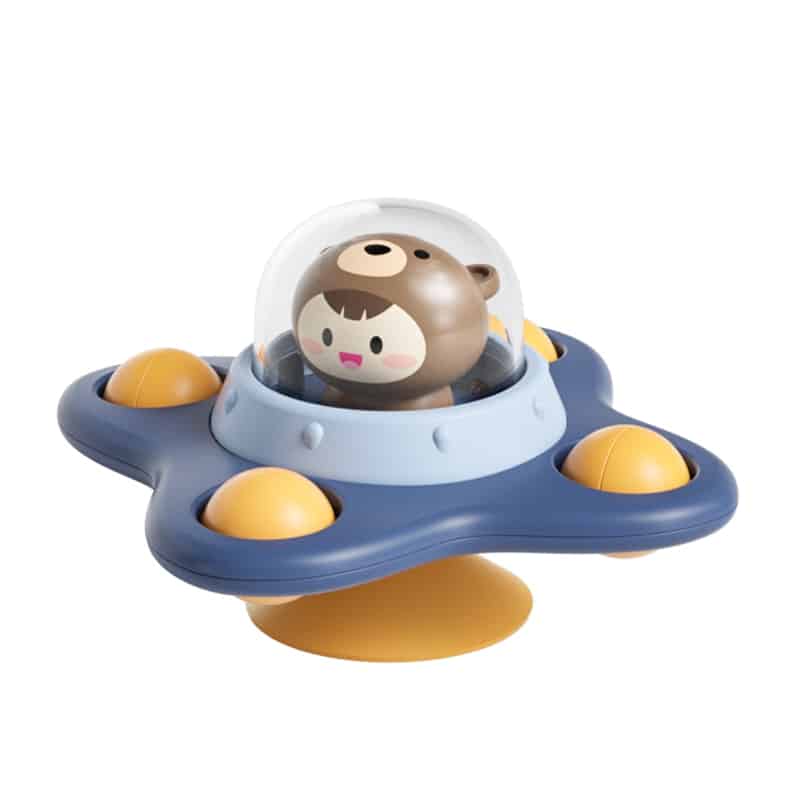 Un Spinner de Bain pour Baignoire en forme de vaisseau spatial avec un ours à l'intérieur.