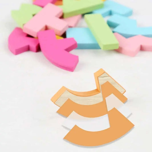 Un Tangram Coeur Coloré en bois coloré disposé sur une surface blanche.