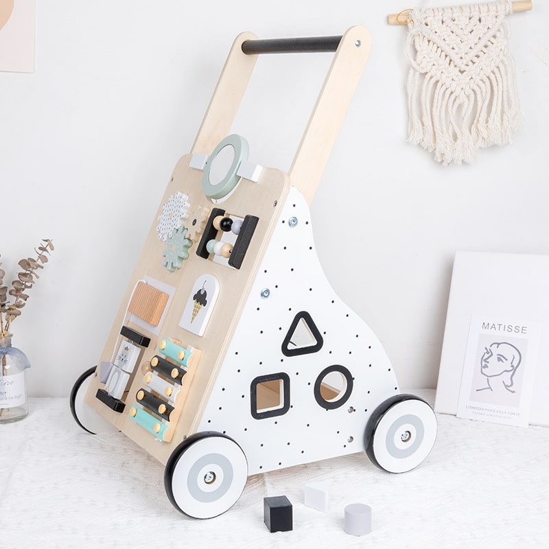 Un Trotteur pousseur bébé multi-activités en Couleurs pastel.